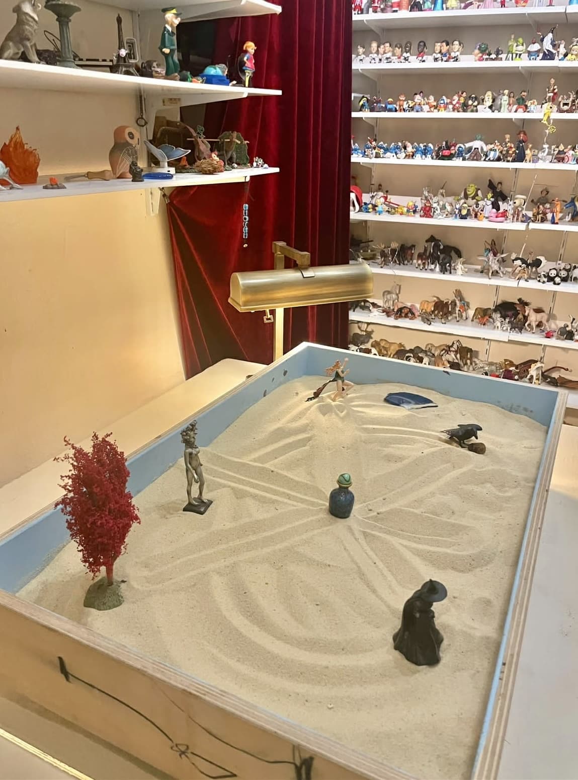 Miniature figures in a sand tray for sandplay therapy
